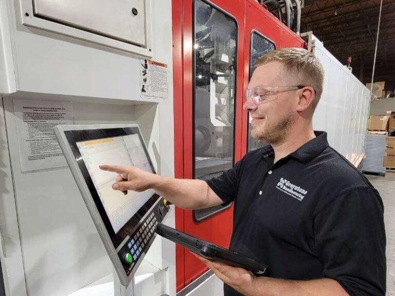 Employee working with machinery on the factory floor.
